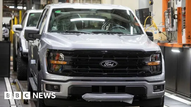 Engenheiro humano inspecionando veículo em fábrica da Ford, com câmeras e sensores visíveis